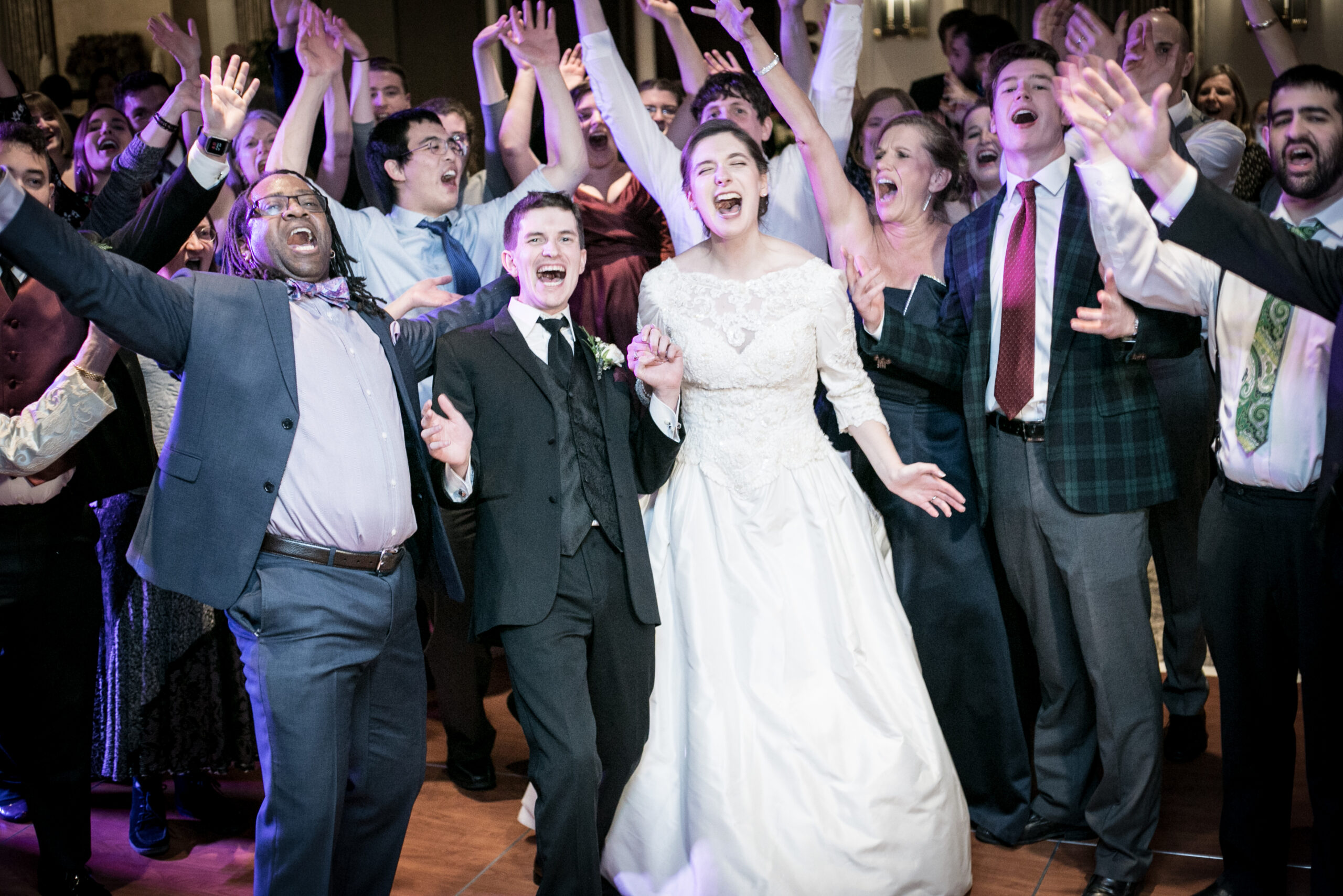 Marz and wedding party singing loudly into the camera.